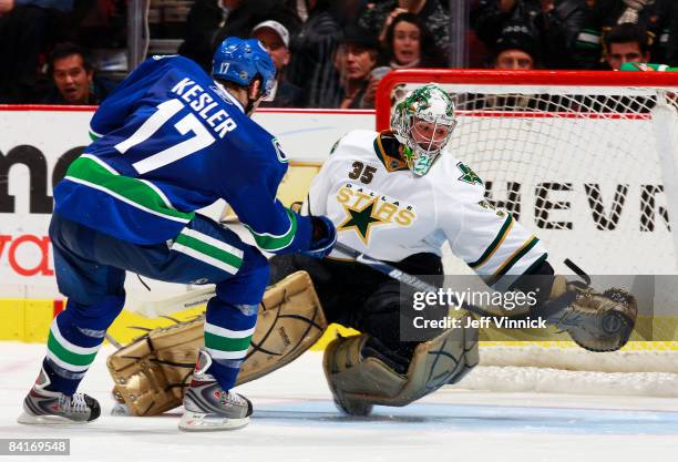 Ryan Kesler of the Vancouver Canucks shoots the puck past Marty Turco of the Dallas Stars in the shootout during their game at General Motors Place...