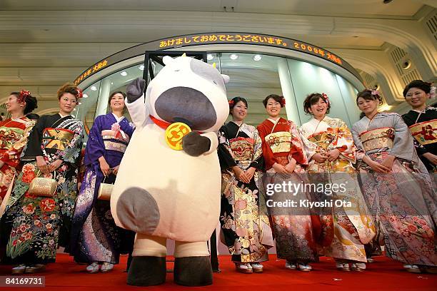 Women dressed in kimonos and a man in costume characterizing the 'Year of the Ox' pose as they attend the opening ceremony to celebrate the start of...