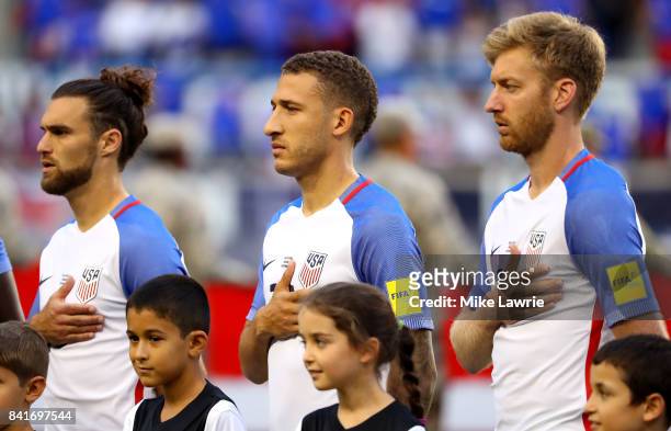 Graham Zusi, Fabian Johnson and Tim Ream of the United States look on during the national anthem before the FIFA 2018 World Cup Qualifier against...