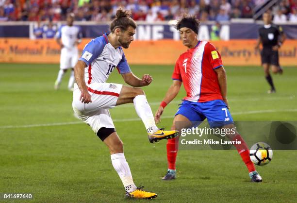 Graham Zusi of the United States shoots against Cristian Bolanos of Costa Rica in the first half during the FIFA 2018 World Cup Qualifier at Red Bull...