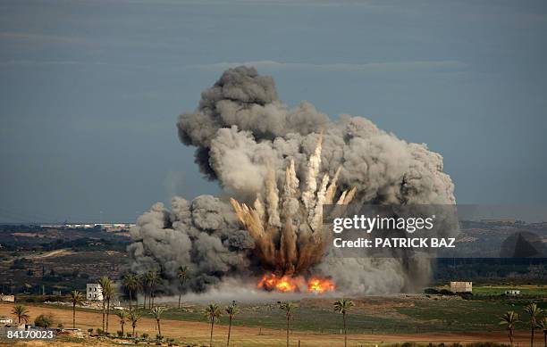 Picture taken from the Israeli side of the border with the Gaza Strip shows a bomb dropped by an Israeli air force F-16 jet exploding in Beit Hanoun,...