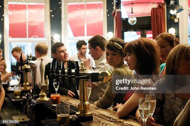 riotous drinking party in public bar  - british pub stock-fotos und bilder