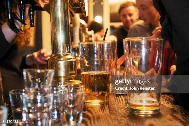 riotous drinking party in public bar  - london pub stock pictures, royalty-free photos & images