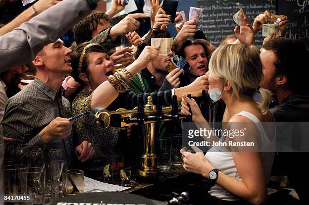 riotous drinking party in public bar  - atestado fotografías e imágenes de stock