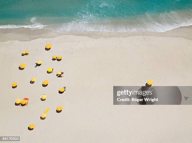 One person isolated from group on beach