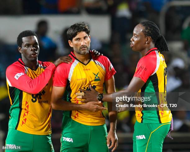 In this handout image provided by CPL T20, Sohail Tanvir Chadwick Walton and Steven Jacobs of Guyana Amazon Warriors celebrate the dismissal of...