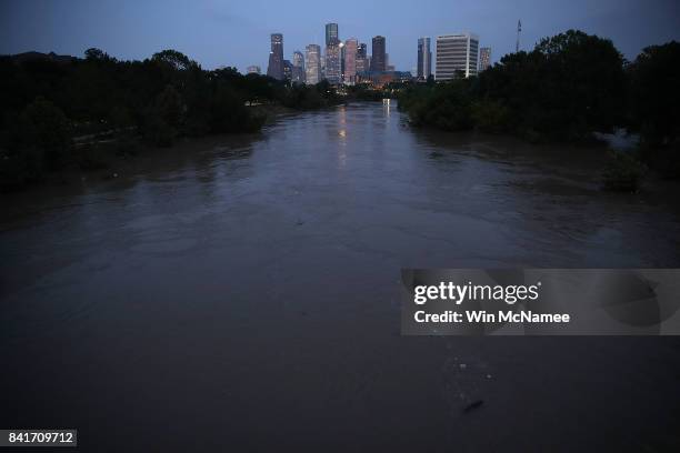 Buffalo Bayou, swollen with floodwaters in the wake of Hurricane Harvey, is shown with the Houston skyline in the background September 1, 2017 in...