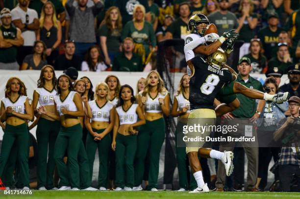 Wide receiver Olabisi Johnson of the Colorado State Rams attempts to catch a pass that is broken up by defensive back Anthony Julmisse of the...