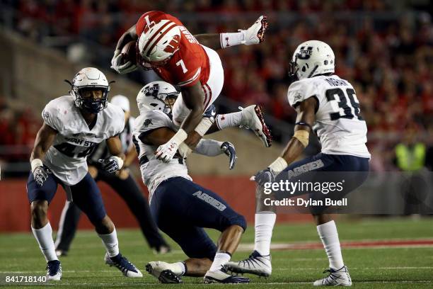 Suli Tamaivena of the Utah State Aggies tackles Bradrick Shaw of the Wisconsin Badgers in the third quarter at Camp Randall Stadium on September 1,...