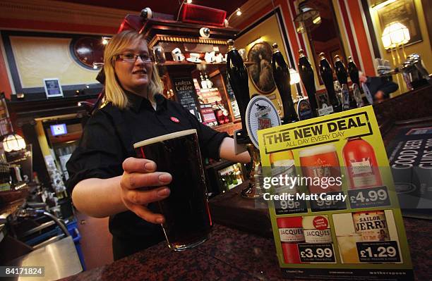 Member of the bar staff pours a pint of beer which is being currently sold in outlets of the pub chain JD Wetherspoon for 99p a pint on January 5,...