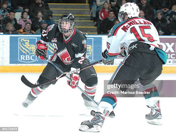 Joey Kornelson of the Moose Jaw Warriors is checked by Brandon McMillan of the Kelowna Rockets aon January 3, 2009 at Prospera Place in Kelowna,...