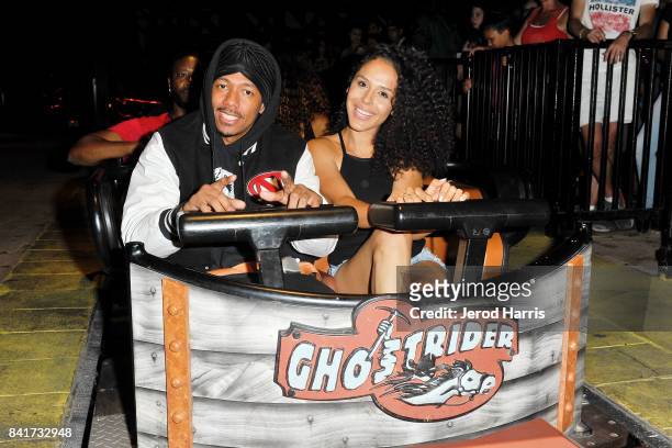 Actor Nick Cannon and Brittany Bell ride the 'Ghostrider' Roller Coaster at Knott's Berry Farm on September 1, 2017 in Buena Park, California.