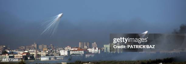 Israeli artillery shells explode over the northern town of Beit Lahia in the Gaza Strip on January 4 as seen from the Israeli side of the Israel-Gaza...