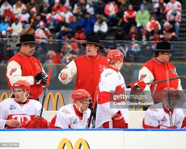 Head Coach Mike Babcock and assitant coaches Paul MacLean and Brad McCrimmon of the Detroit Red Wings stand behind the bench during a NHL game...