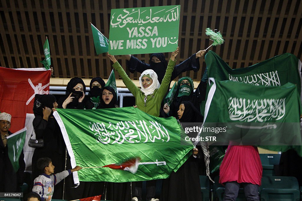 Saudi football fans hold national flags