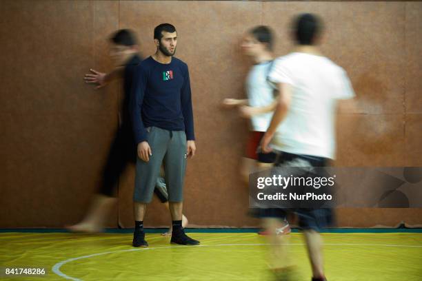 Islam, a trainor from the TOAC Wrestling Club looks at other wrestlers warming up before a training. On 1st September 2017 in Toulouse, France.