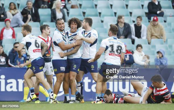 Kevin Proctor of the Titans celebrates with teammates after scoring a try during the round 26 NRL match between the Sydney Roosters and the Gold...