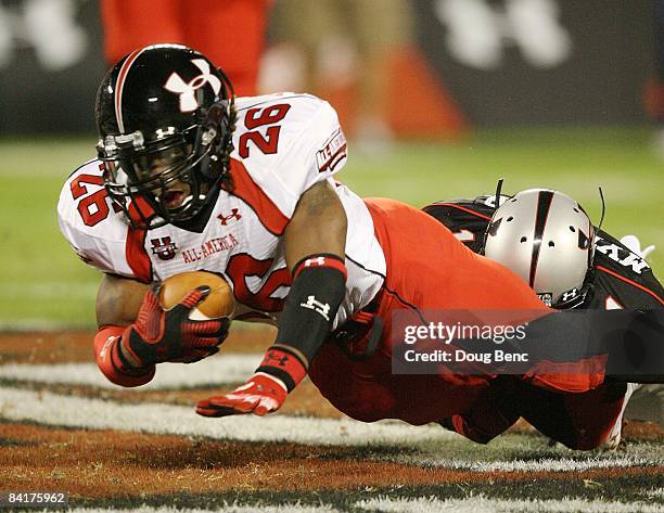 Running back Trent Richardson of the white team is brought down by safety Darren Myles Jr. #1 of the black team in the All America Under Armour...