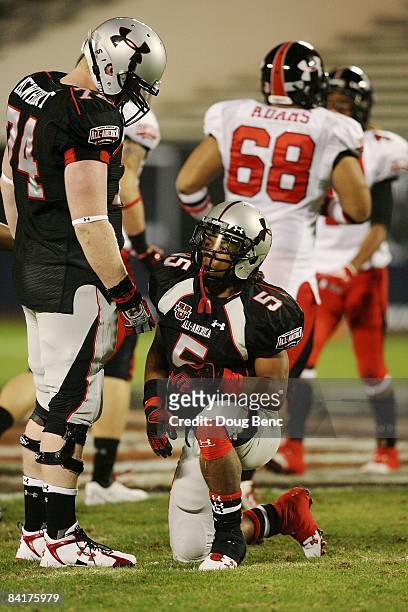Running back Jaamal Berry of the black team is helped up by center Jack Mewhort after Berry fumbled in the All America Under Armour Football Game at...