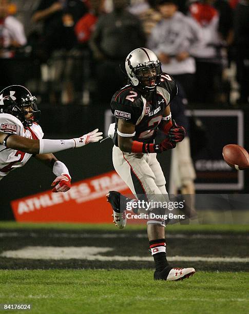 Wide receiver Duron Carter of the black team has the ball knocked away by safety Devonte Holloman of the white team in the All America Under Armour...