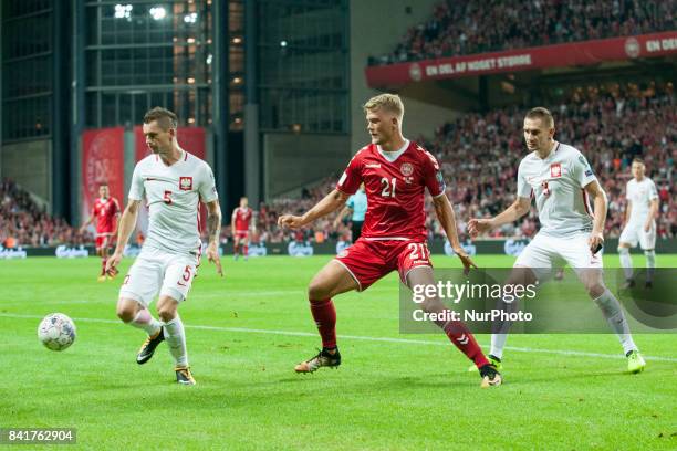 Krzysztof Maczynski and Artur Jedrzejczyk fight for the ball with Andreas Cornelius of Denmark during the FIFA World Cup 2018 Qualifying Round...