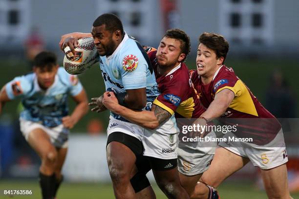 Jone Macilai of Northland tries to break through the tackle of Aleki Morris and Mike Molloy of Southland during the round three Mitre 10 Cup match...