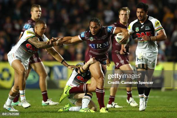 Martin Taupau of the Sea Eagles is tackled during the round 26 NRL match between the Manly Sea Eagles and the Penrith Panthers at Lottoland on...