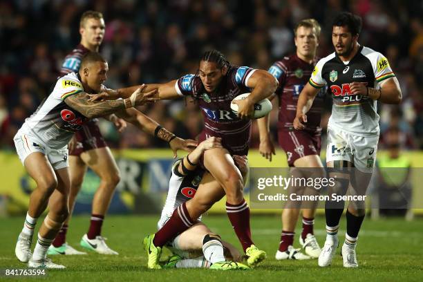 Martin Taupau of the Sea Eagles is tackled during the round 26 NRL match between the Manly Sea Eagles and the Penrith Panthers at Lottoland on...