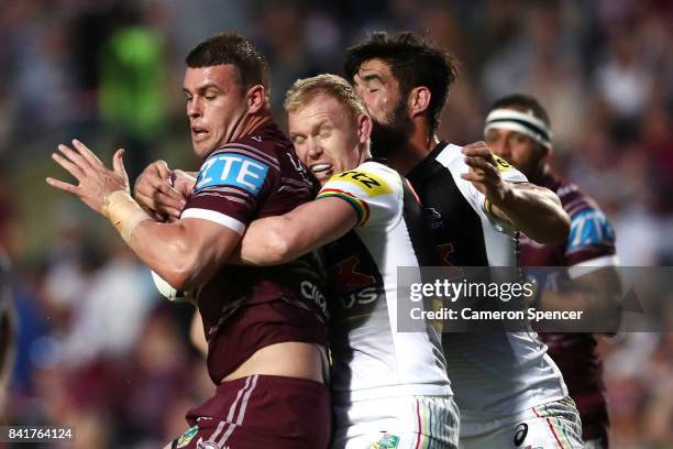 Darcy Lussick of the Sea Eagles is tackled during the round 26 NRL match between the Manly Sea Eagles and the Penrith Panthers at Lottoland on...