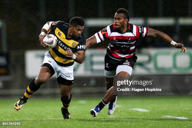 Waisake Naholo of Taranaki is tackled by Tevita Nabura of Counties Manukau during the round three Mitre 10 Cup match between Taranaki and Counties...