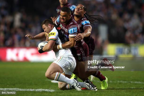 Trent Merrin of the Panthers is tackled during the round 26 NRL match between the Manly Sea Eagles and the Penrith Panthers at Lottoland on September...