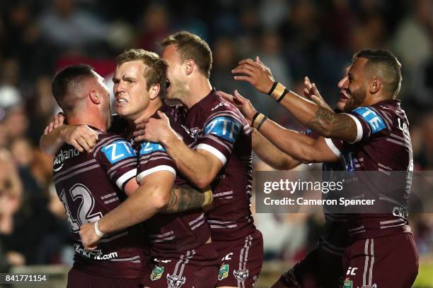 Curtis Sironen of the Sea Eagles celebrates scoring a try with team mates during the round 26 NRL match between the Manly Sea Eagles and the Penrith...