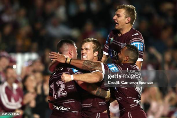 Curtis Sironen of the Sea Eagles celebrates scoring a try with team mates during the round 26 NRL match between the Manly Sea Eagles and the Penrith...