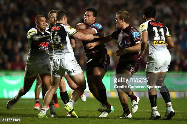 Lloyd Perrett of the Sea Eagles is tackled during the round 26 NRL match between the Manly Sea Eagles and the Penrith Panthers at Lottoland on...