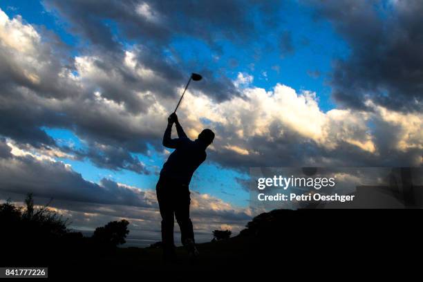 a golfer tee's off into the clouds. - high contrast athlete stock pictures, royalty-free photos & images