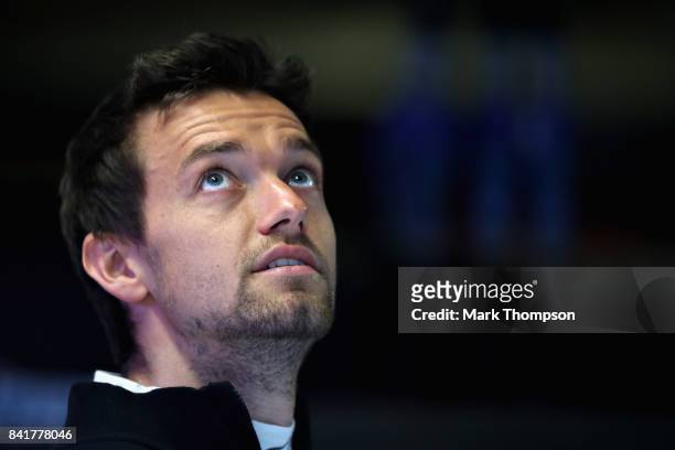 Jolyon Palmer of Great Britain and Renault Sport F1 looks on in the garage during a rain delayed final practice for the Formula One Grand Prix of...