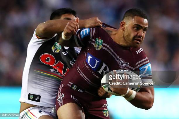 Dylan Walker of the Sea Eagles is tackled during the round 26 NRL match between the Manly Sea Eagles and the Penrith Panthers at Lottoland on...