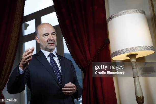 Pierre Moscovici, economic commissioner for the European Union , gestures while speaking during a Bloomberg Television interview at the Ambrosetti...