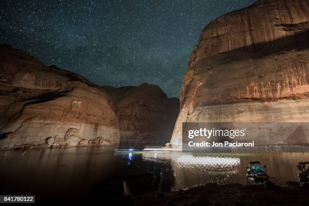 light streaks of boat passing by at night through escalante canyon in lake powell - escalante canyons bildbanksfoton och bilder