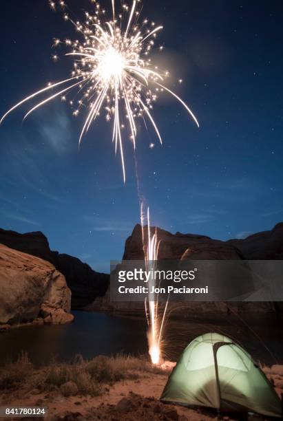 a firework exploding above the rim of escalante canyon above lake powell - escalante canyons bildbanksfoton och bilder