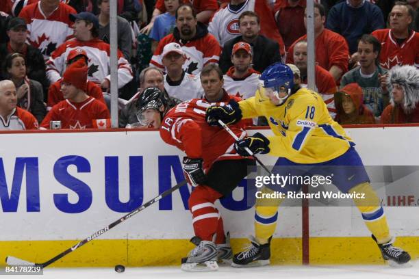 Cody Hodgson of Team Canada stick handles the puck while being defended by Joakim Andersson of Team Sweden during the Gold Medal Game of the IIHF...