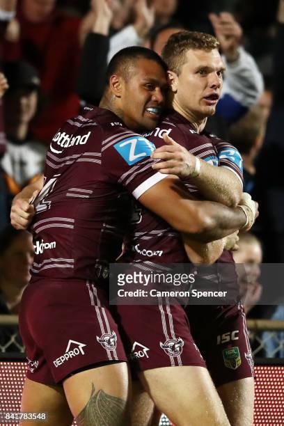 Tom Trbojevic of the Sea Eagles is congratulated by team mates after scoring a try during the round 26 NRL match between the Manly Sea Eagles and the...