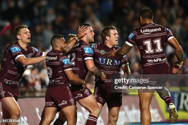 Curtis Sironen of the Sea Eagles is congratulated by team mates after scoring a try during the round 26 NRL match between the Manly Sea Eagles and...