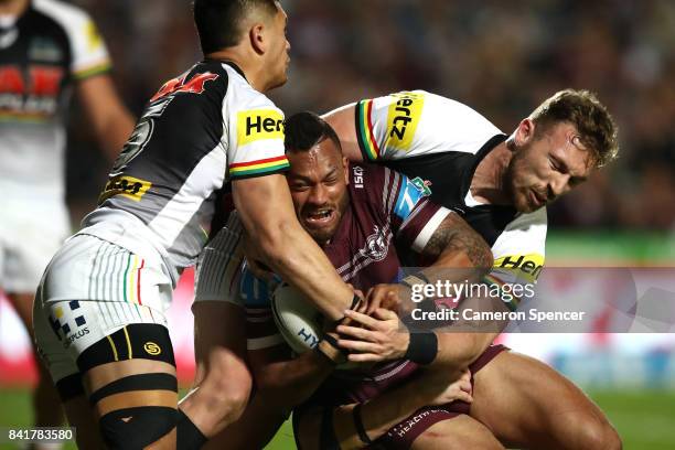 Apisai Koroisau of the Sea Eagles is tackled during the round 26 NRL match between the Manly Sea Eagles and the Penrith Panthers at Lottoland on...