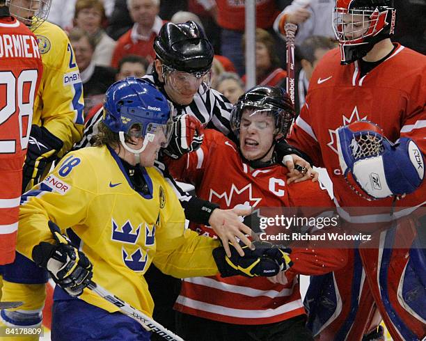 Thomas Hickey of Team Canada shoves Joakim Andersson of Team Sweden with play stopped during the Gold Medal Game of the IIHF World Junior...