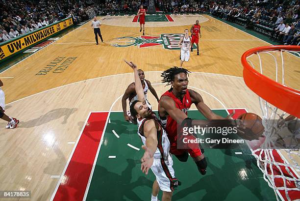 Chris Bosh of the Toronto Raptors shoots a layup against Dan Gadzuric of the Milwaukee Bucks on January 5, 2009 at the Bradley Center in Milwaukee,...