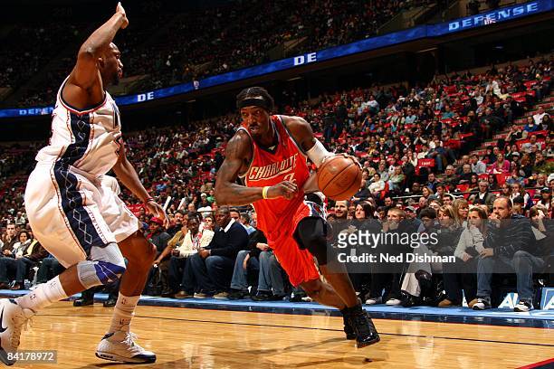 Gerald Wallace of the Charlotte Bobcats drives to the basket against Trenton Hassell of the New Jersey Nets during the game at the IZOD Center on...