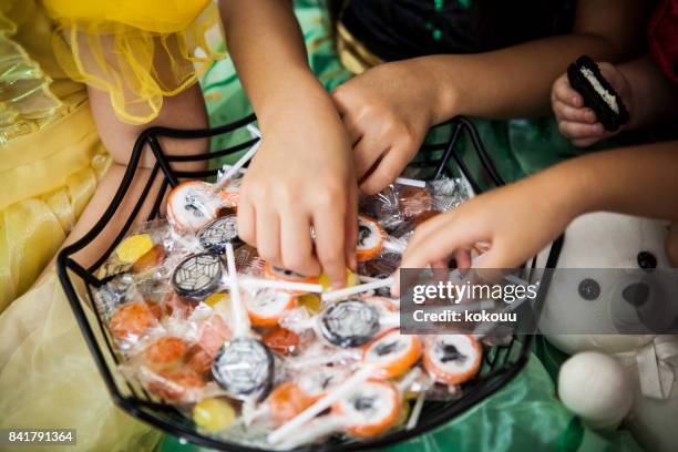 the girls in the costume of princess have chosen which lollipop to eat. - halloween candy stock pictures, royalty-free photos & images