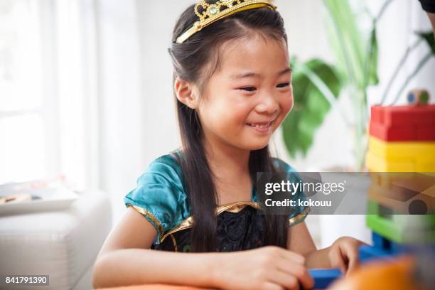 a girl in a princess's costume is playing with a toy. - arm made of vegetables stock pictures, royalty-free photos & images