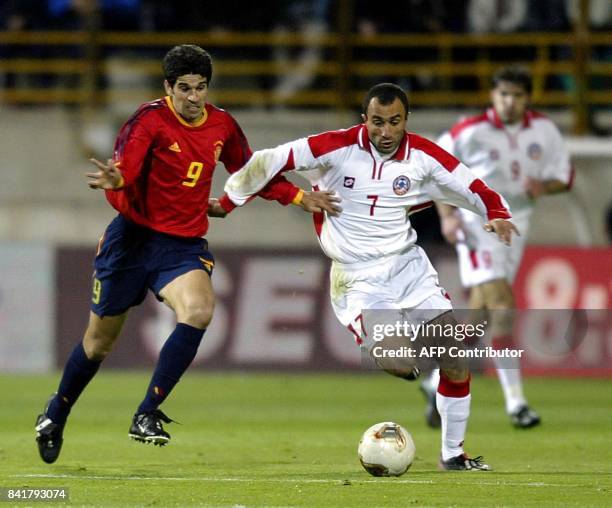 Spanish Juan Carlos Valeron fights for the ball with Petrosyan of Armenia during their Euro 2004 qualifying group 6 match in Jose Amilivia stadium of...